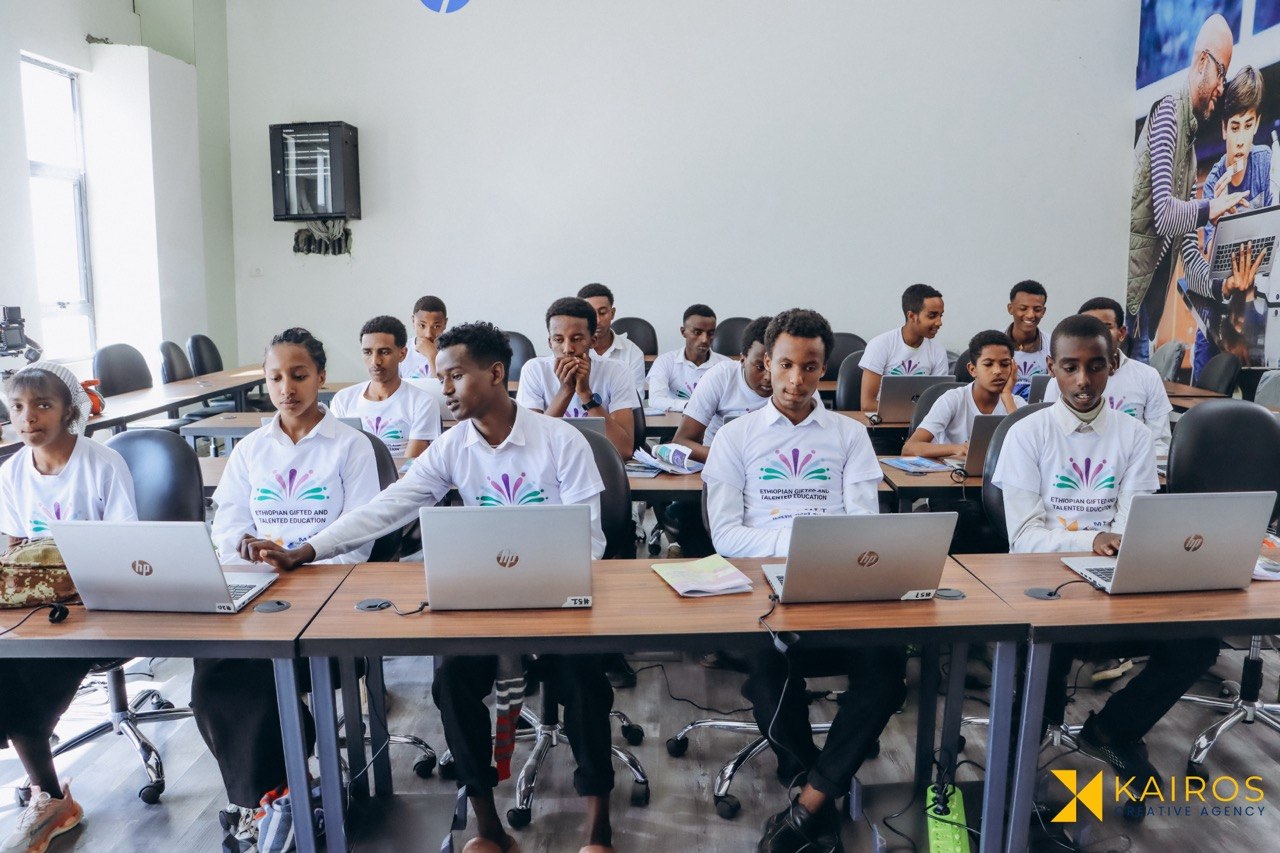 Students learning cybersecurity on laptops during the Burayu program